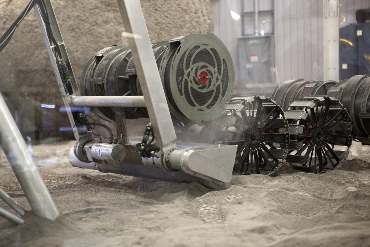 An integrated test of the MARCO POLO/Mars Pathfinder in-situ resource utilization, or ISRU, system takes place at NASA’s Kennedy Space Center in Florida. A mockup of MARCO POLO, an ISRU propellant production technology demonstration simulated mission, is tested in a regolith bin with RASSOR 2.0, the Regolith Advanced Surface Systems Operations Robot.  On the surface of Mars, mining robots like RASSOR will dig down into the regolith and take the material to a processing plant where usable elements such as hydrogen, oxygen and water can be extracted for life support systems. Regolith also shows promise for both construction and creating elements for rocket fuel.