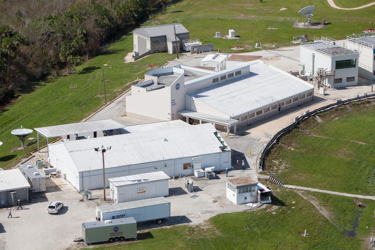 The NASA TV Support Building at the NASA News Center is seen during an aerial survey of NASA's Kennedy Space Center in Florida on Saturday. The survey was performed to identify structures and facilities that may have sustained damage from Hurricane Matthew as the storm passed to the east of Kennedy on Oct. 6 and 7, 2016. Officials determined that the center received some isolated roof damage, damaged support buildings, a few downed power lines, and limited water intrusion. Beach erosion also occurred, although the storm surge was less than expected. NASA closed the center ahead of the storm’s onset and only a small team of specialists known as the Rideout Team was on the center as the storm approached and passed.