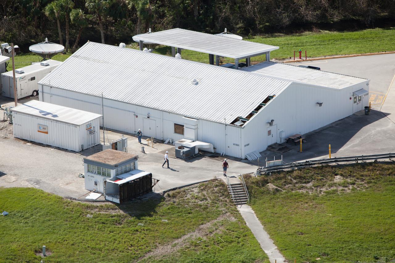 The NASA TV Support Building at the NASA News Center is seen during an aerial survey of NASA's Kennedy Space Center in Florida on Saturday. The survey was performed to identify structures and facilities that may have sustained damage from Hurricane Matthew as the storm passed to the east of Kennedy on Oct. 6 and 7, 2016. Officials determined that the center received some isolated roof damage, damaged support buildings, a few downed power lines, and limited water intrusion. Beach erosion also occurred, although the storm surge was less than expected. NASA closed the center ahead of the storm’s onset and only a small team of specialists known as the Rideout Team was on the center as the storm approached and passed.