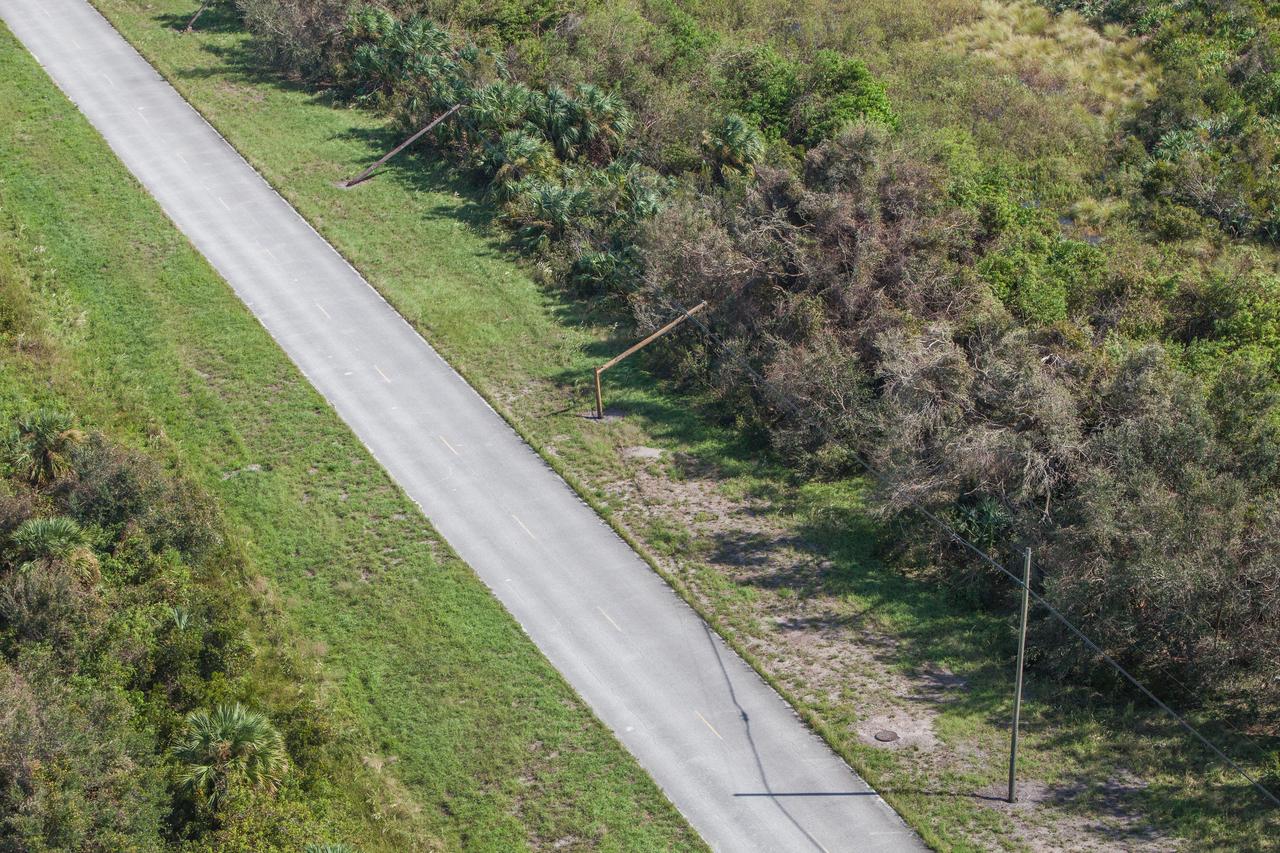 Damaged power lines are seen during an aerial survey of NASA's Kennedy Space Center in Florida on Saturday. The survey was performed to identify structures and facilities that may have sustained damage from Hurricane Matthew as the storm passed to the east of Kennedy on Oct. 6 and 7, 2016. Officials determined that the center received some isolated roof damage, damaged support buildings, a few downed power lines, and limited water intrusion. Beach erosion also occurred, although the storm surge was less than expected. NASA closed the center ahead of the storm’s onset and only a small team of specialists known as the Rideout Team was on the center as the storm approached and passed.