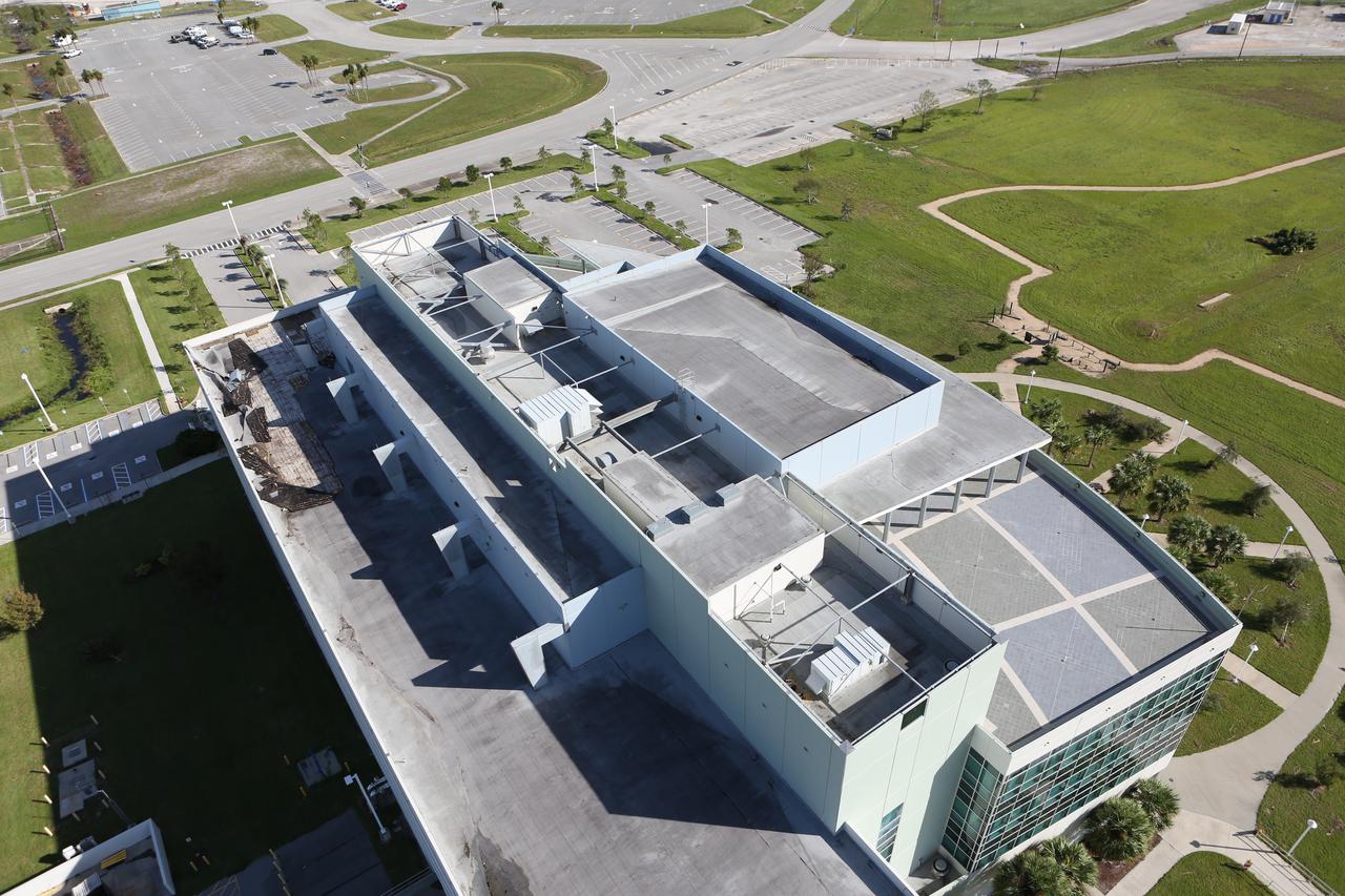 The roof of the Operations Support Building II is seen during an aerial survey of NASA's Kennedy Space Center in Florida on Saturday. The survey was performed to identify structures and facilities that may have sustained damage from Hurricane Matthew as the storm passed to the east of Kennedy on Oct. 6 and 7, 2016. Officials determined that the center received some isolated roof damage, damaged support buildings, a few downed power lines, and limited water intrusion. Beach erosion also occurred, although the storm surge was less than expected. NASA closed the center ahead of the storm’s onset and only a small team of specialists known as the Rideout Team was on the center as the storm approached and passed.