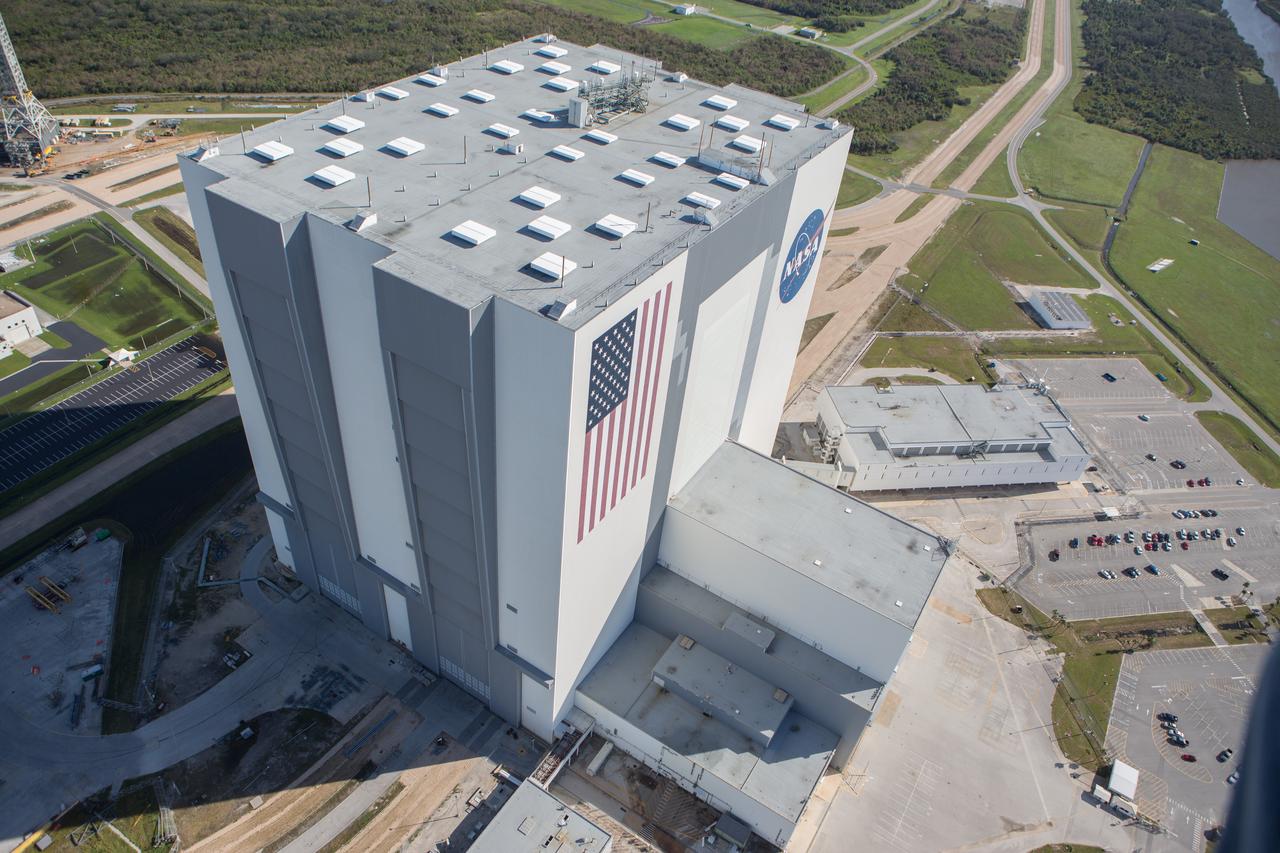 The Vehicle Assembly Building is seen during an aerial survey of NASA's Kennedy Space Center in Florida on Saturday. The survey was performed to identify structures and facilities that may have sustained damage from Hurricane Matthew as the storm passed to the east of Kennedy on Oct. 6 and 7, 2016. Officials determined that the center received some isolated roof damage, damaged support buildings, a few downed power lines, and limited water intrusion. Beach erosion also occurred, although the storm surge was less than expected. NASA closed the center ahead of the storm’s onset and only a small team of specialists known as the Rideout Team was on the center as the storm approached and passed.