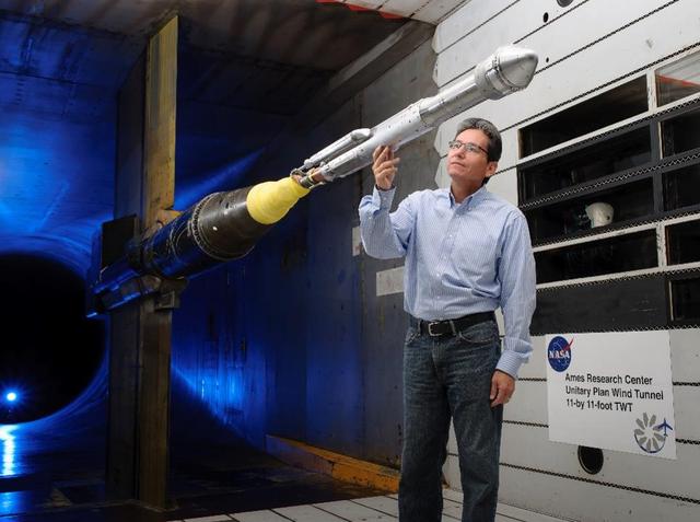 An engineer works with a model of a United Launch Alliance Atlas V rocket with a Boeing CST-100 Starliner capsule inside a wind tunnel at NASA's Ames Research Center in California. The Starliner/Atlas V system is under development by Boeing and ULA in partnership with NASA's Commercial Crew Program to launch astronauts to the International Space Station.