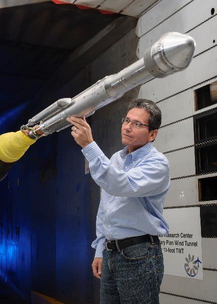 An engineer works with a model of a United Launch Alliance Atlas V rocket with a Boeing CST-100 Starliner capsule inside a wind tunnel at NASA's Ames Research Center in California. The Starliner/Atlas V system is under development by Boeing and ULA in partnership with NASA's Commercial Crew Program to launch astronauts to the International Space Station.