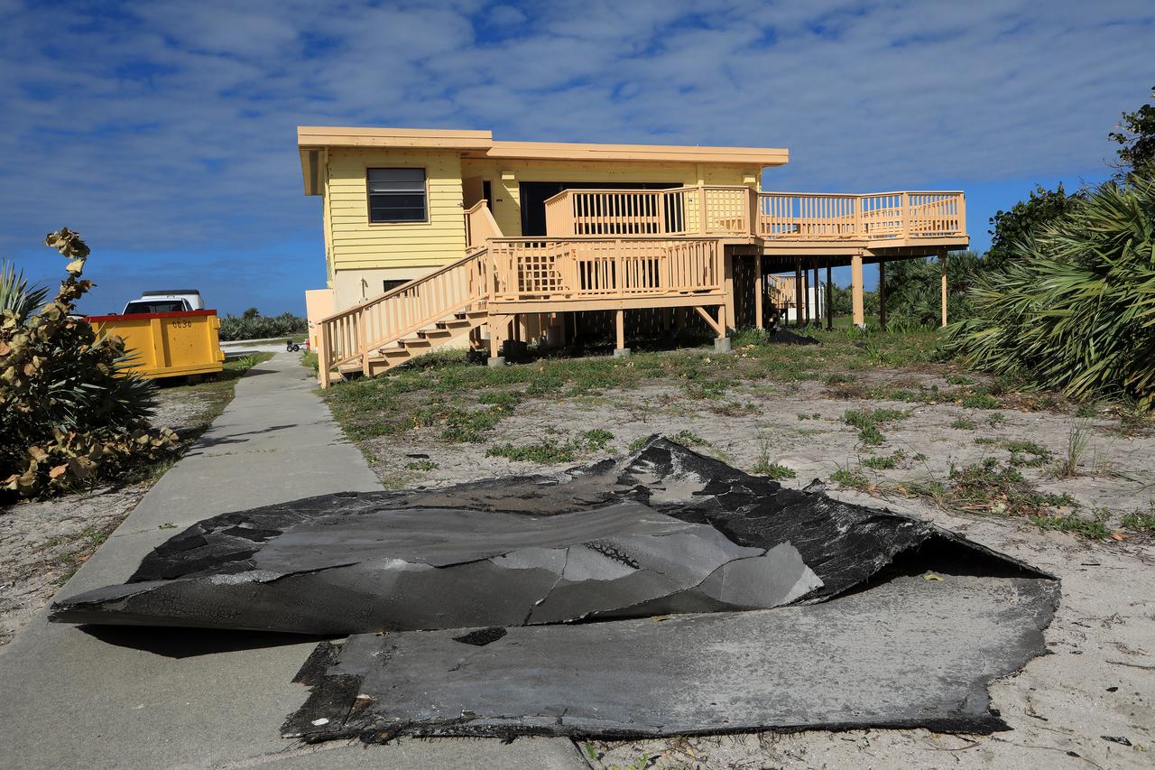 Roofing materials, blown loose by Hurricane Matthew, lie on the ground behind the Beach House at NASA’s Kennedy Space Center in Florida.  Members of the Disaster Assessment and Recovery Team (DART) are working on repairs to the facility following Hurricane Matthew, which passed to the east of Kennedy on Oct. 6 and 7, 2016. The center received some isolated roof damage, damaged support buildings, a few downed power lines, and limited water intrusion. Beach erosion also occurred, although the storm surge was less than expected.