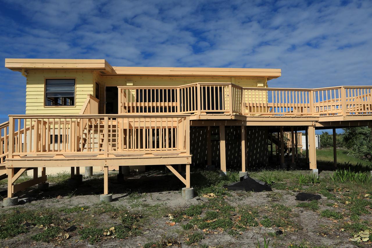 Roofing materials, blown loose by Hurricane Matthew, are visible on the ground below the deck of the Beach House at NASA’s Kennedy Space Center in Florida.  Members of the Disaster Assessment and Recovery Team (DART) are working on repairs to the facility following Hurricane Matthew, which passed to the east of Kennedy on Oct. 6 and 7, 2016. The center received some isolated roof damage, damaged support buildings, a few downed power lines, and limited water intrusion. Beach erosion also occurred, although the storm surge was less than expected.