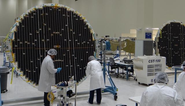 Engineers work with the solar array for Boeing's CST-100 Starliner spacecraft at Spectrolab in Sylmar, California. The solar arrays will power the Starliner as it flies through space and while it is docked to the International Space Station. Photo credit: Boeing
