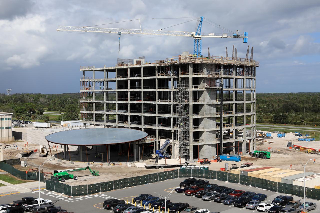 A large crane towers overhead as the new, seven-story headquarters building takes shape in the industrial area at NASA’s Kennedy Space Center in Florida. The 200,000-square-foot facility will anchor the spaceport’s Central Campus and house about 500 NASA civil service and contractor employees. The building will be more energy efficient than the current Headquarters building and will feature the latest in office and administrative building technology to fulfill Kennedy's role as the premiere multi-user spaceport for NASA and, increasingly, commercial entities.