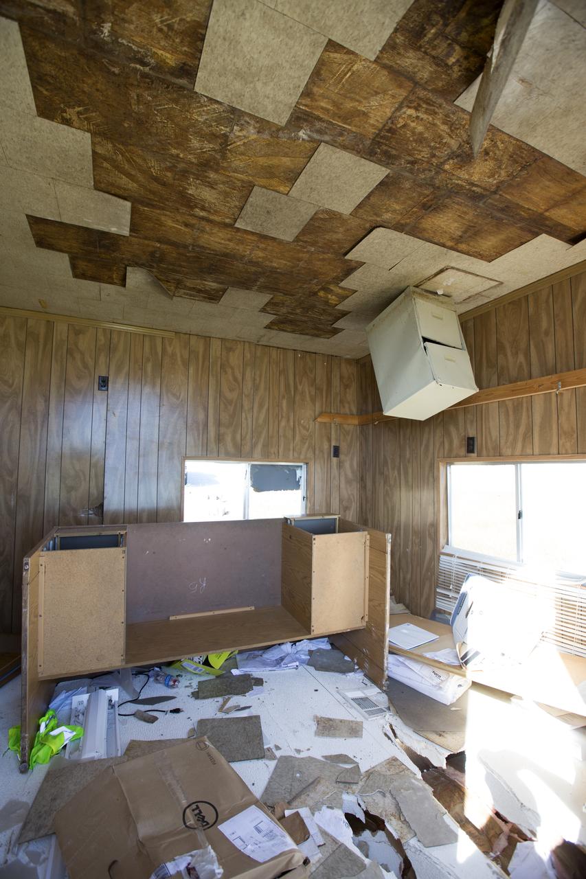 Ceiling and furniture damage caused by Hurricane Matthew is seen inside a support building in the Launch Complex 39 area at NASA's Kennedy Space Center in Florida.  Assessments and repairs are in progress at various structures and facilities across the spaceport, part of the ongoing recovery from Hurricane Matthew, which passed to the east of Kennedy on Oct. 6 and 7, 2016. The center received some isolated roof damage, damaged support buildings, a few downed power lines, and limited water intrusion. Beach erosion also occurred, although the storm surge was less than expected.