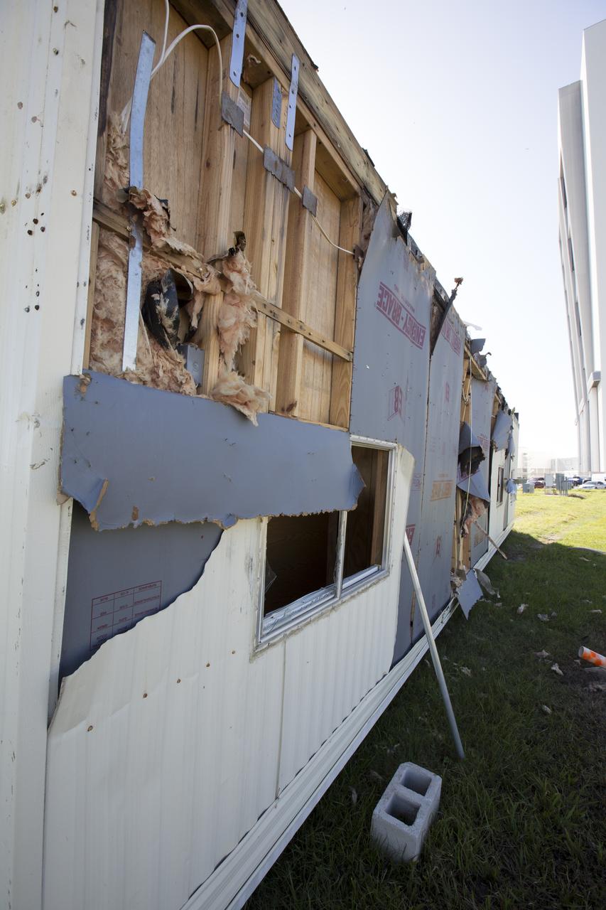 Siding damage caused by Hurricane Matthew is seen inside a support building in the Launch Complex 39 area at NASA's Kennedy Space Center in Florida.  Assessments and repairs are in progress at various structures and facilities across the spaceport, part of the ongoing recovery from Hurricane Matthew, which passed to the east of Kennedy on Oct. 6 and 7, 2016. The center received some isolated roof damage, damaged support buildings, a few downed power lines, and limited water intrusion. Beach erosion also occurred, although the storm surge was less than expected.