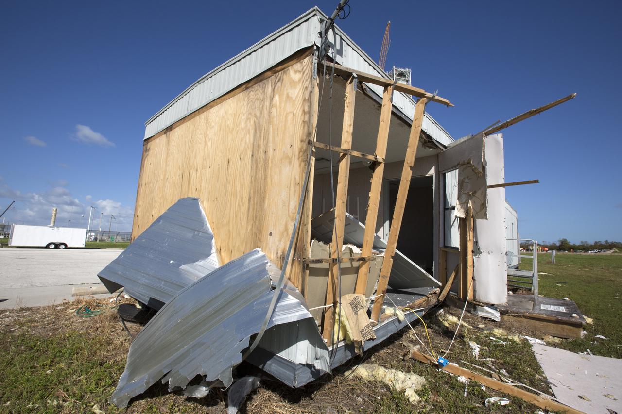 A construction trailer damaged by Hurricane Matthew is seen in the Launch Complex 39 area at NASA's Kennedy Space Center in Florida.  Assessments and repairs are in progress at various structures and facilities across the spaceport, part of the ongoing recovery from Hurricane Matthew, which passed to the east of Kennedy on Oct. 6 and 7, 2016. The center received some isolated roof damage, damaged support buildings, a few downed power lines, and limited water intrusion. Beach erosion also occurred, although the storm surge was less than expected.