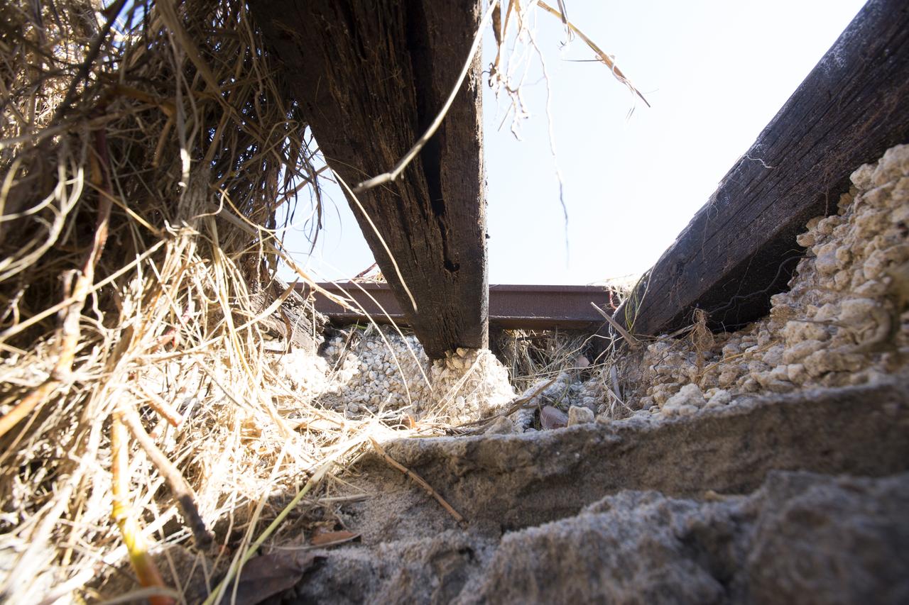 Erosion caused by Hurricane Matthew has worn away sections of the ground beneath the NASA Railroad at Kennedy Space Center in Florida.  A portion of the line near the ocean was used during the Apollo era, although some portions were used to deliver commodities to the nearby Cape Canaveral Air Force Station through the end of the Titan program. NASA determined it was financially and ecologically advantageous to leave the tracks in place. Hurricane Matthew, a Category 3 storm, passed to the east of Kennedy on Oct. 6 and 7, 2016. The center received some isolated roof damage, damaged support buildings, a few downed power lines, and limited water intrusion. Beach erosion also occurred, although the storm surge was less than expected.