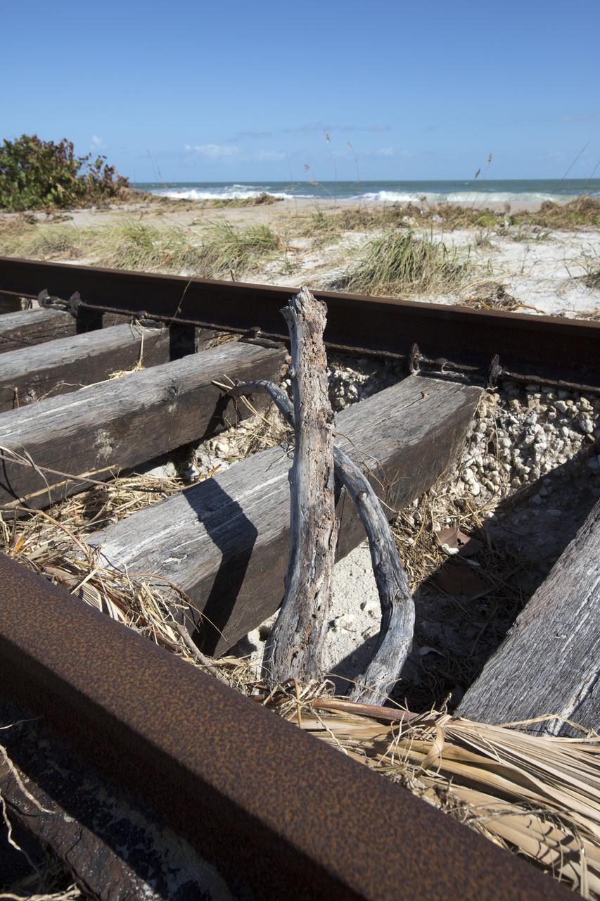 Plant debris and ground erosion left behind by Hurricane Matthew affect a stretch of the NASA Railroad at Kennedy Space Center in Florida.  A portion of the line near the ocean was used during the Apollo era, although some portions were used to deliver commodities to the nearby Cape Canaveral Air Force Station through the end of the Titan program. NASA determined it was financially and ecologically advantageous to leave the tracks in place. Hurricane Matthew, a Category 3 storm, passed to the east of Kennedy on Oct. 6 and 7, 2016. The center received some isolated roof damage, damaged support buildings, a few downed power lines, and limited water intrusion. Beach erosion also occurred, although the storm surge was less than expected.