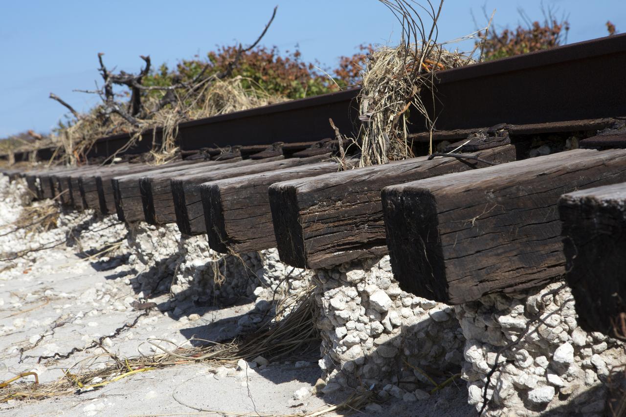 Plant debris and ground erosion left behind by Hurricane Matthew affect a stretch of the NASA Railroad at Kennedy Space Center in Florida.  A portion of the line near the ocean was used during the Apollo era, although some portions were used to deliver commodities to the nearby Cape Canaveral Air Force Station through the end of the Titan program. NASA determined it was financially and ecologically advantageous to leave the tracks in place. Hurricane Matthew, a Category 3 storm, passed to the east of Kennedy on Oct. 6 and 7, 2016. The center received some isolated roof damage, damaged support buildings, a few downed power lines, and limited water intrusion. Beach erosion also occurred, although the storm surge was less than expected.