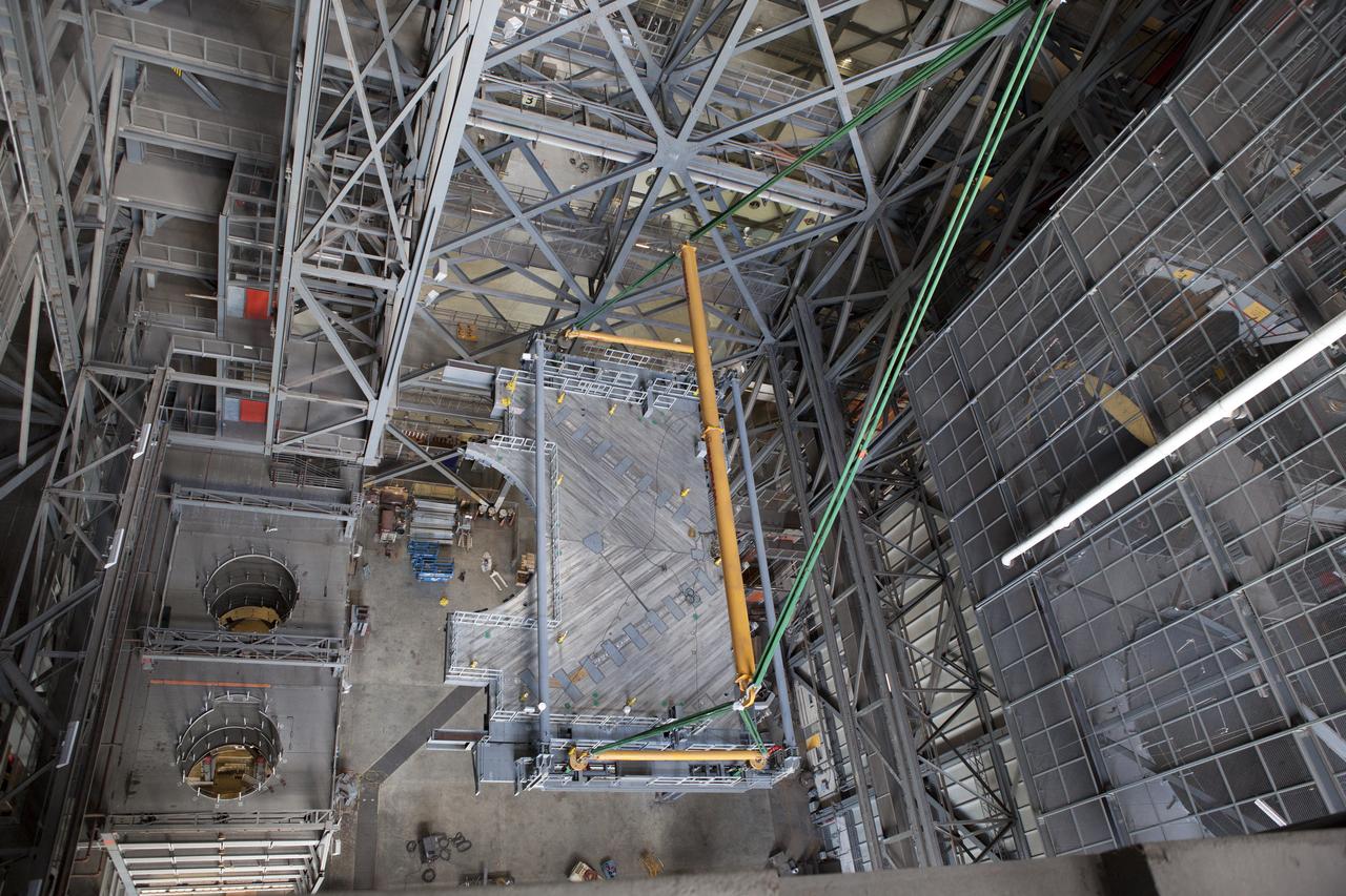 A heavy-lift crane lifts the first half of the C-level work platforms, C south, for NASA’s Space Launch System (SLS) rocket, up from the transfer aisle floor of the Vehicle Assembly Building (VAB) at NASA’s Kennedy Space Center in Florida. Large Tandemloc bars have been attached to the platform to keep it level during lifting and installation. The C platform will be installed on the south side of High Bay 3. The C platforms are the eighth of 10 levels of work platforms that will surround and provide access to the SLS rocket and Orion spacecraft for Exploration Mission 1. The Ground Systems Development and Operations Program is overseeing upgrades and modifications to VAB High Bay 3, including installation of the new work platforms, to prepare for NASA’s Journey to Mars.