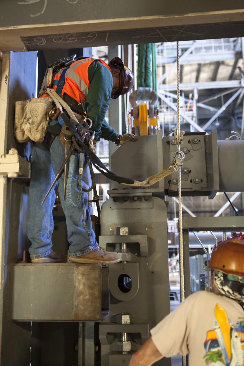 Inside the Vehicle Assembly Building at NASA’s Kennedy Space Center in Florida, construction workers assist with the installation of the first half of the C-level work platforms, C south, for NASA’s Space Launch System (SLS) rocket. The large bolts that hold the platform in place on the south wall are being secured. The C platforms are the eighth of 10 levels of work platforms that will surround and provide access to the SLS rocket and Orion spacecraft for Exploration Mission 1. The Ground Systems Development and Operations Program is overseeing upgrades and modifications to VAB High Bay 3, including installation of the new work platforms, to prepare for NASA’s Journey to Mars.
