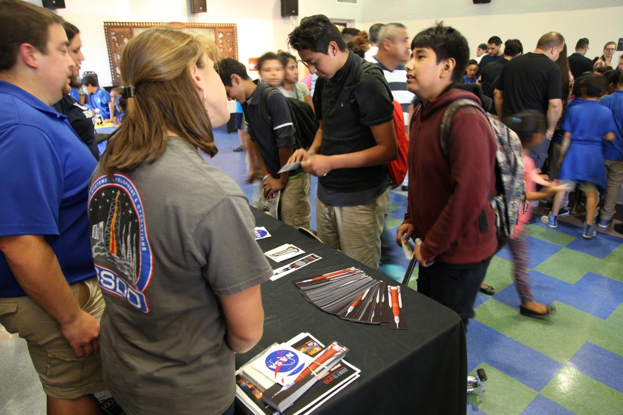 Students visit the displays at the Logan Heights Library in San Diego, California, during the “52 Weeks of Science” celebration. The Ground Systems Development and Operations (GSDO) Program is participating in the special event with a Journey to Mars display before the start of Underway Recovery Test 5 using a test version of the Orion spacecraft in the Pacific Ocean off the coast of California. The test will allow NASA, Orion manufacturer Lockheed Martin and the U.S. Navy to demonstrate and evaluate the recovery processes, procedures, hardware and personnel necessary for recovery of the Orion crew module on its return from a deep space mission. Orion is the exploration spacecraft designed to carry astronauts to destinations not yet explored by humans, including an asteroid and NASA Journey to Mars. It will have emergency abort capability, sustain the crew during space travel and provide safe re-entry from deep space return velocities. Orion is scheduled to launch atop NASA’s Space Launch System rocket in 2018. For more information, visit http://www.nasa.gov/orion.