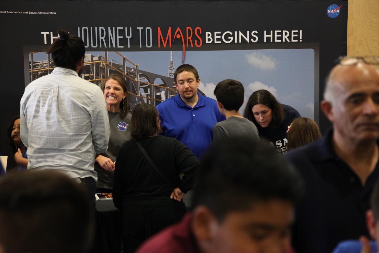 Students and parents visit the displays at the Logan Heights Library in San Diego, California, during the “52 Weeks of Science” celebration. The Ground Systems Development and Operations (GSDO) Program is participating in the special event with a Journey to Mars display before the start of Underway Recovery Test 5 using a test version of the Orion spacecraft in the Pacific Ocean off the coast of California. The test will allow NASA, Orion manufacturer Lockheed Martin and the U.S. Navy to demonstrate and evaluate the recovery processes, procedures, hardware and personnel necessary for recovery of the Orion crew module on its return from a deep space mission. Orion is the exploration spacecraft designed to carry astronauts to destinations not yet explored by humans, including an asteroid and NASA Journey to Mars. It will have emergency abort capability, sustain the crew during space travel and provide safe re-entry from deep space return velocities. Orion is scheduled to launch atop NASA’s Space Launch System rocket in 2018. For more information, visit http://www.nasa.gov/orion. 