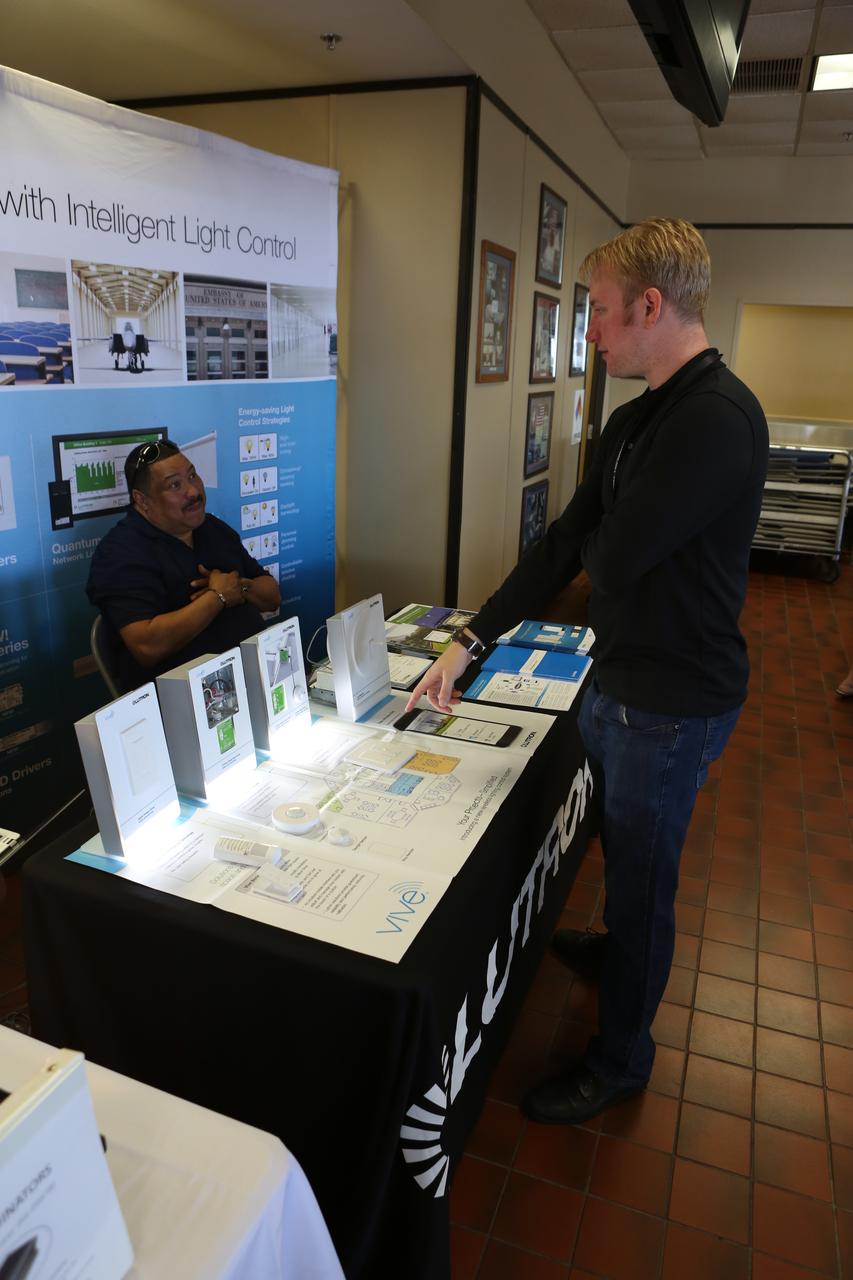 Cory Taylor, an energy and water conservation specialist at Kennedy Space Center, absorbs information from Mark Gonzalez, a sales engineer with MC2 during Energy Awareness Day at the Multi-Function Facility on Oct. 20. Every third Thursday of October, civil servants, contractors and several energy utilities promote the awareness of our sustainability goals at Kennedy Space Center and at home. Photo credit: Cory Huston