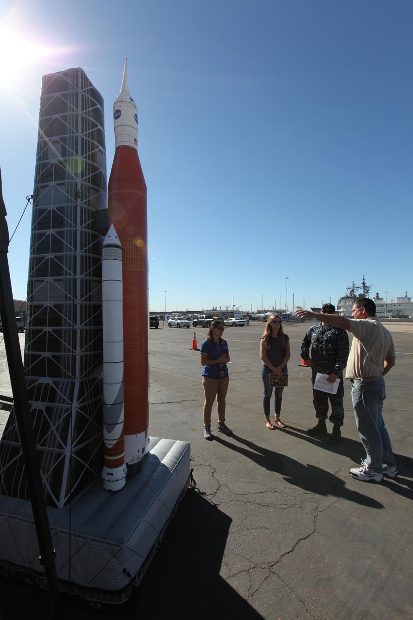 A base employee checks out an inflatable scale model of NASA’s Space Launch System rocket with Orion on the mobile launcher at Naval Base San Diego in California. Service members, base employees and their families had the opportunity to view a test version of the Orion crew module before Underway Recovery Test 5 (URT-5). NASA, Orion manufacturer Lockheed Martin and the U.S. Navy will head out to sea with the Orion test vehicle aboard the USS San Diego to demonstrate and evaluate the recovery processes, procedures, hardware and personnel necessary for recovery of Orion on its return from a deep space mission. Orion is the exploration spacecraft designed to carry astronauts to destinations not yet explored by humans, including an asteroid and NASA Journey to Mars. It will have emergency abort capability, sustain the crew during space travel and provide safe re-entry from deep space return velocities. Orion is scheduled to launch atop NASA’s Space Launch System rocket in 2018. For more information, visit http://www.nasa.gov/orion.