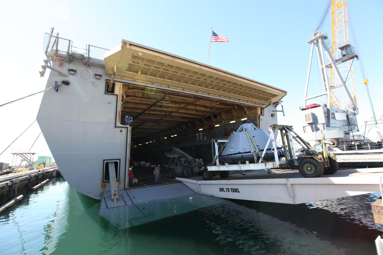 The test version of the Orion crew module is transported into the well deck of the USS San Diego at Naval Base San Diego in California. NASA, Orion manufacturer Lockheed Martin and the U.S. Navy will head out to sea with the Orion test spacecraft aboard for Underway Recovery Test 5 (URT-5) in the Pacific Ocean off the coast of California. During URT-5, the team will demonstrate and evaluate the recovery processes, procedures, hardware and personnel necessary for recovery of Orion on its return from a deep space mission. Orion is the exploration spacecraft designed to carry astronauts to destinations not yet explored by humans, including an asteroid and NASA Journey to Mars. It will have emergency abort capability, sustain the crew during space travel and provide safe re-entry from deep space return velocities. Orion is scheduled to launch atop NASA’s Space Launch System rocket in 2018. For more information, visit http://www.nasa.gov/orion. 