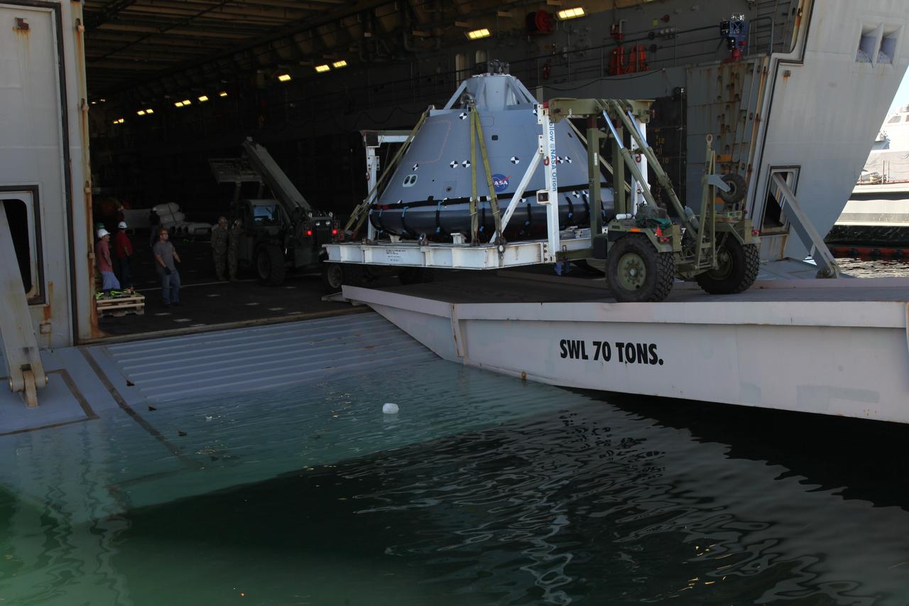The test version of the Orion crew module is transported into the well deck of the USS San Diego at Naval Base San Diego in California. NASA, Orion manufacturer Lockheed Martin and the U.S. Navy will head out to sea with the Orion test spacecraft aboard for Underway Recovery Test 5 (URT-5) in the Pacific Ocean off the coast of California. During URT-5, the team will demonstrate and evaluate the recovery processes, procedures, hardware and personnel necessary for recovery of Orion on its return from a deep space mission. Orion is the exploration spacecraft designed to carry astronauts to destinations not yet explored by humans, including an asteroid and NASA Journey to Mars. It will have emergency abort capability, sustain the crew during space travel and provide safe re-entry from deep space return velocities. Orion is scheduled to launch atop NASA’s Space Launch System rocket in 2018. For more information, visit http://www.nasa.gov/orion.