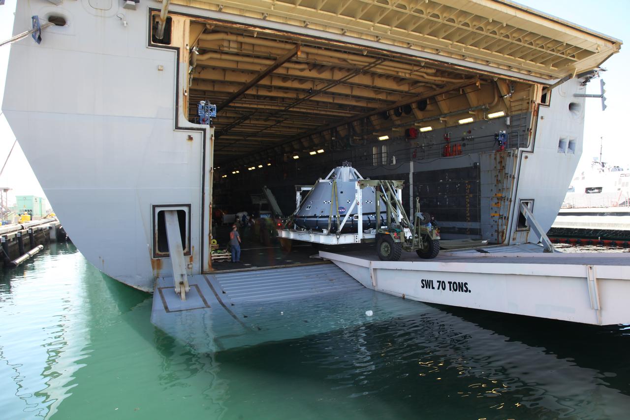 The test version of the Orion crew module is transported into the well deck of the USS San Diego at Naval Base San Diego in California. NASA, Orion manufacturer Lockheed Martin and the U.S. Navy will head out to sea with the Orion test spacecraft aboard for Underway Recovery Test 5 (URT-5) in the Pacific Ocean off the coast of California. During URT-5, the team will demonstrate and evaluate the recovery processes, procedures, hardware and personnel necessary for recovery of Orion on its return from a deep space mission. Orion is the exploration spacecraft designed to carry astronauts to destinations not yet explored by humans, including an asteroid and NASA Journey to Mars. It will have emergency abort capability, sustain the crew during space travel and provide safe re-entry from deep space return velocities. Orion is scheduled to launch atop NASA’s Space Launch System rocket in 2018. For more information, visit http://www.nasa.gov/orion. 