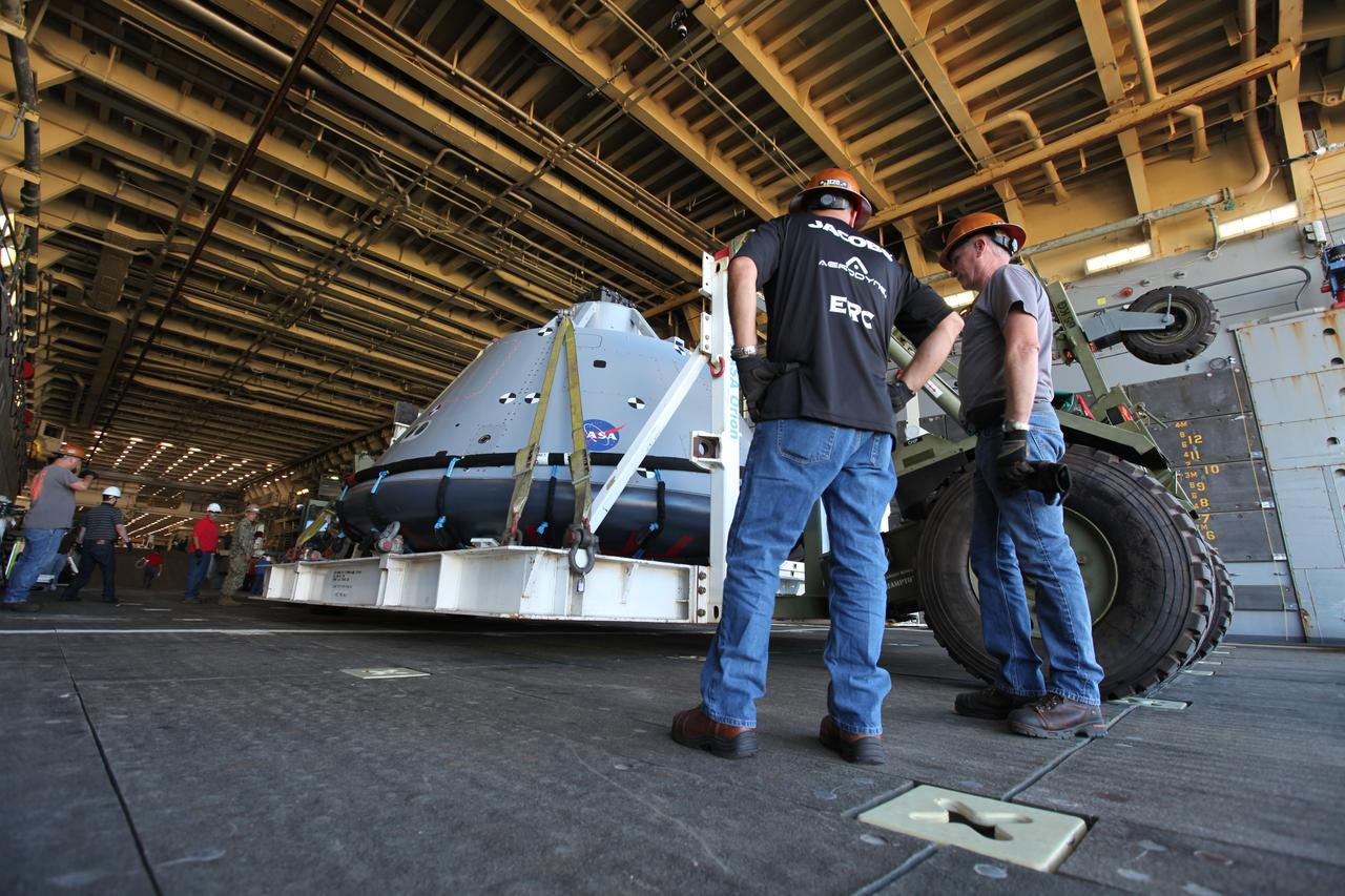 NASA and contractor team members monitor the progress as the test version of the Orion crew module arrives in the well deck of the USS San Diego at Naval Base San Diego in California. NASA, Orion manufacturer Lockheed Martin and the U.S. Navy will head out to sea with the Orion test spacecraft aboard for Underway Recovery Test 5 (URT-5) in the Pacific Ocean off the coast of California. During URT-5, the team will demonstrate and evaluate the recovery processes, procedures, hardware and personnel necessary for recovery of Orion on its return from a deep space mission. Orion is the exploration spacecraft designed to carry astronauts to destinations not yet explored by humans, including an asteroid and NASA Journey to Mars. It will have emergency abort capability, sustain the crew during space travel and provide safe re-entry from deep space return velocities. Orion is scheduled to launch atop NASA’s Space Launch System rocket in 2018. For more information, visit http://www.nasa.gov/orion. 