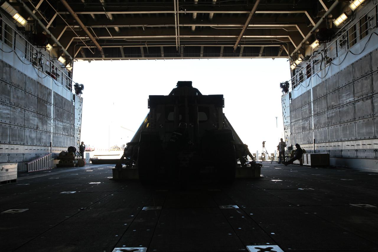 A contract of light and shadow. The test version of the Orion crew module has been transported into the well deck of the USS San Diego at Naval Base San Diego in California, as viewed from inside the ship. NASA, Orion manufacturer Lockheed Martin and the U.S. Navy will head out to sea with the Orion test spacecraft aboard for Underway Recovery Test 5 (URT-5) in the Pacific Ocean off the coast of California. During URT-5, the team will demonstrate and evaluate the recovery processes, procedures, hardware and personnel necessary for recovery of Orion on its return from a deep space mission. Orion is the exploration spacecraft designed to carry astronauts to destinations not yet explored by humans, including an asteroid and NASA Journey to Mars. It will have emergency abort capability, sustain the crew during space travel and provide safe re-entry from deep space return velocities. Orion is scheduled to launch atop NASA’s Space Launch System rocket in 2018. For more information, visit http://www.nasa.gov/orion. 