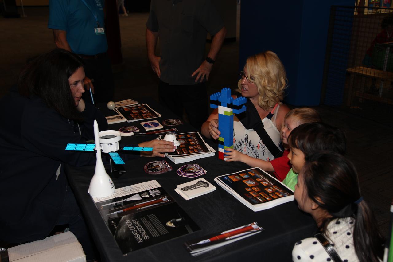 Melissa Jones, left, Landing and Recovery director with NASA’s Ground Systems Development and Operations Program speaks to visitors to the Reuben H. Fleet Science Center in San Diego, California, during a “Genius in the House” event. GSDO participated in several outreach events to students and the general public before the start of the Orion Underway Recovery Test 5 (URT-5) using a test version of the Orion crew module in the Pacific Ocean off the coast of California. URT-5 will allow NASA, Orion manufacturer Lockheed Martin and the U.S. Navy to demonstrate and evaluate the recovery processes, procedures, hardware and personnel necessary for recovery of the Orion crew module on its return from a deep space mission. Orion is the exploration spacecraft designed to carry astronauts to destinations not yet explored by humans, including an asteroid and NASA’s Journey to Mars. It will have emergency abort capability, sustain the crew during space travel and provide safe re-entry from deep space return velocities. Orion is scheduled to launch atop NASA’s Space Launch System rocket in 2018. For more information, visit http://www.nasa.gov/orion. 