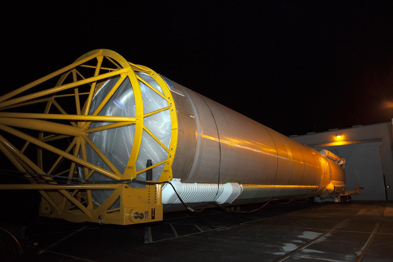The United Launch Alliance Atlas V first stage leaves the Atlas Space Operations Center aboard a transport trailer for delivery to the Vertical Integration Facility at Space Launch Complex 41 at Cape Canaveral Air Force Station in Florida. The Geostationary Operational Environmental Satellite (GOES-R) will launch aboard the Atlas V rocket in November. GOES-R will be the first satellite in a series of next-generation NOAA GOES Satellites.