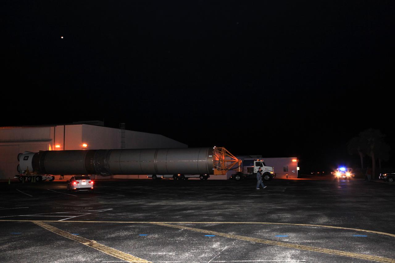The United Launch Alliance Atlas V first stage leaves the Atlas Space Operations Center aboard a transport trailer for delivery to the Vertical Integration Facility at Space Launch Complex 41 at Cape Canaveral Air Force Station in Florida. The Geostationary Operational Environmental Satellite (GOES-R) will launch aboard the Atlas V rocket in November. GOES-R will be the first satellite in a series of next-generation NOAA GOES Satellites.