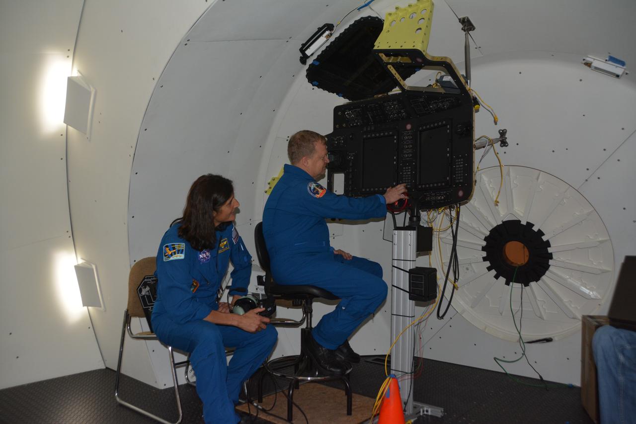 NASA astronauts Suni WIlliams and Eric Boe check the Boeing Mission Simulator at the Boeing facility in St. Louis, Missouri, prior to its completion and shipment to NASA's Johnson Space Center in Houston. The simulator is a full-scale mockup of Boeing's Starliner spacecraft. The simulator will be used to train crews to fly the spacecraft.