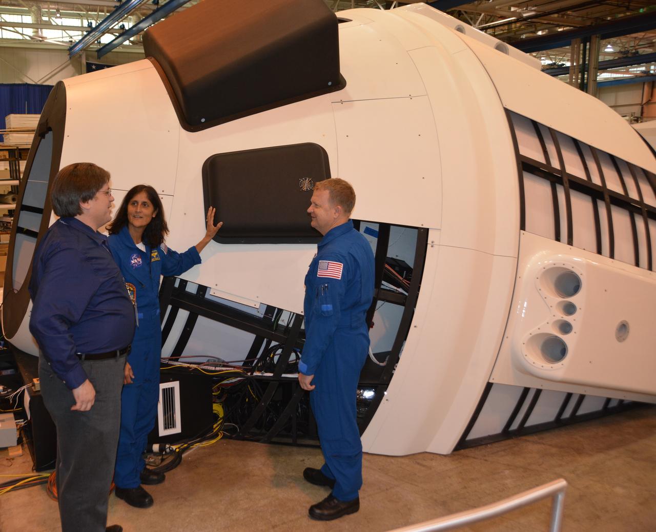 NASA astronauts Suni WIlliams and Eric Boe check the Boeing Mission Simulator at the Boeing facility in St. Louis, Missouri, prior to its completion and shipment to NASA's Johnson Space Center in Houston. The simulator is a full-scale mockup of Boeing's Starliner spacecraft. The simulator will be used to train crews to fly the spacecraft.