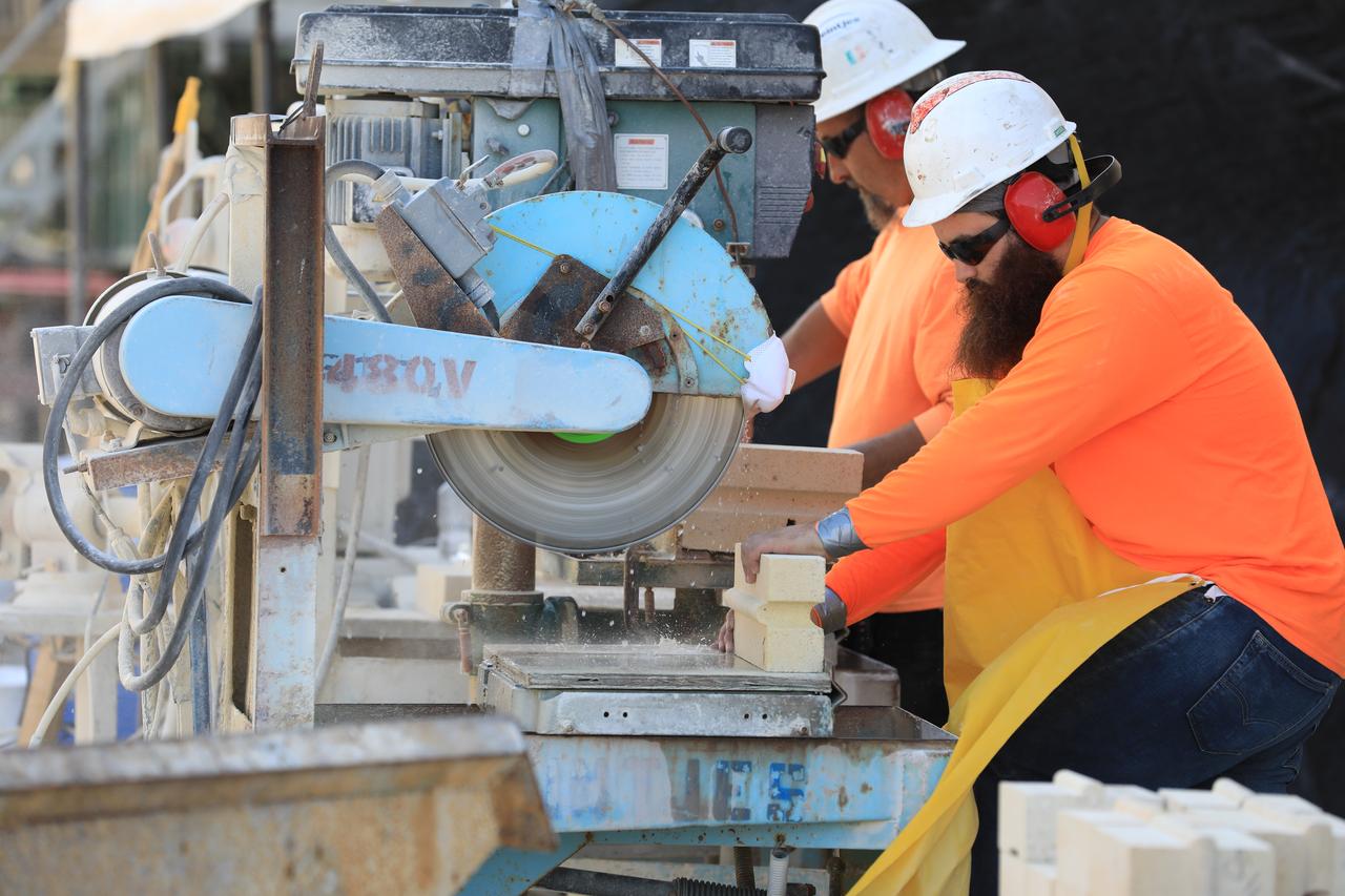 Construction workers with J.P. Donovan of Rockledge, Florida, cut new heat-resistant bricks to size for the concrete walls of the flame trench at Launch Pad 39B at NASA’s Kennedy Space Center in Florida. New heat-resistant bricks are being attached with epoxy mortar to the flame trench walls. The Pad B flame trench is being refurbished to support the launch of NASA’s Space Launch System rocket. The Ground Systems Development and Operations (GSDO) Program at Kennedy is helping transform the space center into a multi-user spaceport and prepare for Exploration Mission 1, deep space missions, and NASA's Journey to Mars. For more information about GSDO, visit: http://www.nasa.gov/groundsystems. 