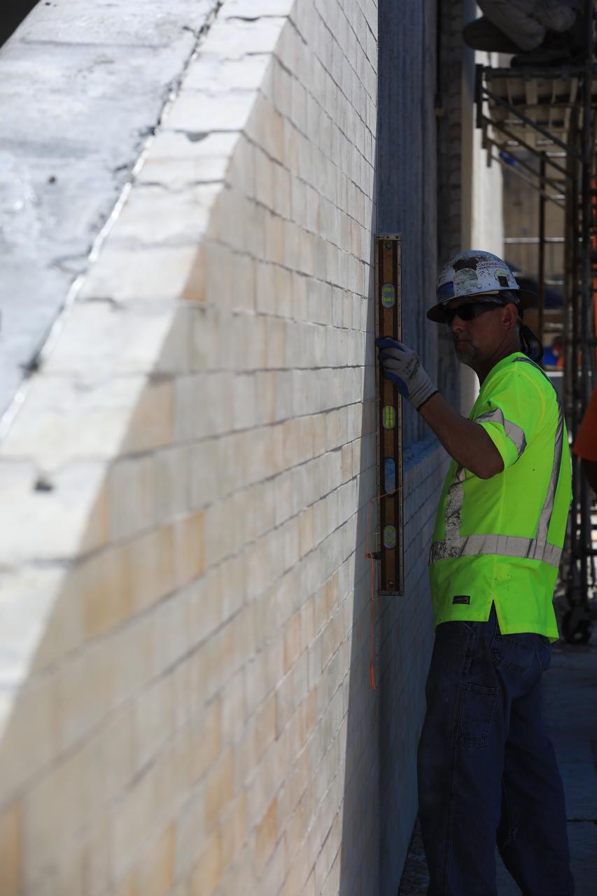 A construction worker with J.P. Donovan of Rockledge, Florida, checks to make sure new heat-resistant bricks attached to the north side of the flame trench are level at Launch Pad 39B at NASA’s Kennedy Space Center in Florida. The Pad B flame trench is being refurbished to support the launch of NASA’s Space Launch System rocket. The Ground Systems Development and Operations (GSDO) Program at Kennedy is helping transform the space center into a multi-user spaceport and prepare for Exploration Mission 1, deep space missions, and NASA's Journey to Mars. For more information about GSDO, visit: http://www.nasa.gov/groundsystems.