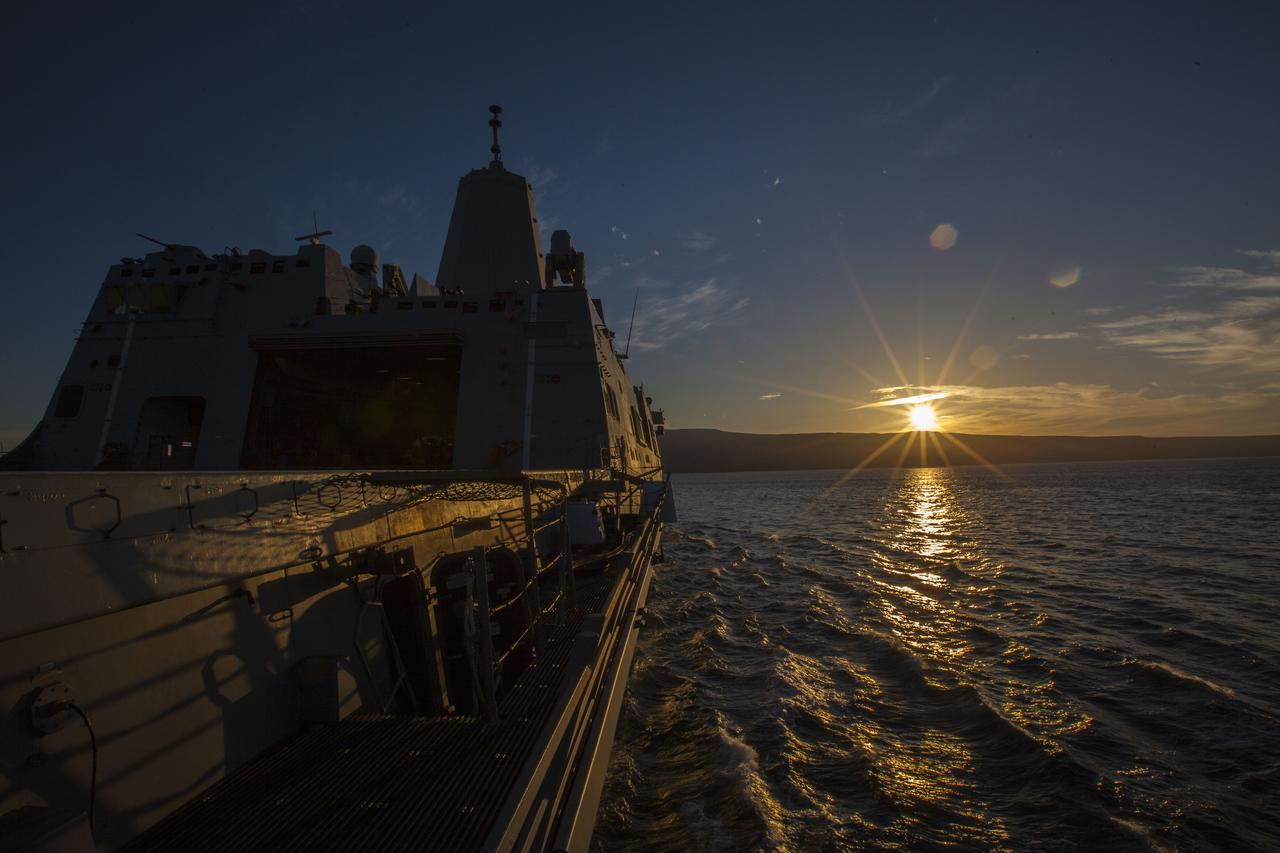 A colorful sunset illuminates the water as the USS San Diego prepares for Underway Recovery Test 5 in the Pacific Ocean off the coast of California. Using a test version of the Orion crew module, NASA's Ground Systems Development and Operations Program and the U.S. Navy will conduct a series of tests to prepare for recovery of Orion on its return from deep space missions. The testing will allow the team to demonstrate and evaluate recovery processes, procedures, hardware and personnel in open waters. Orion is the exploration spacecraft designed to carry astronauts to destinations not yet explored by humans, including an asteroid and NASA's Journey to Mars. It will have emergency abort capability, sustain the crew during space travel and provide safe re-entry from deep space return velocities. Orion is scheduled to launch on NASA's Space Launch System in late 2018. For more information, visit http://www.nasa.gov/orion. 