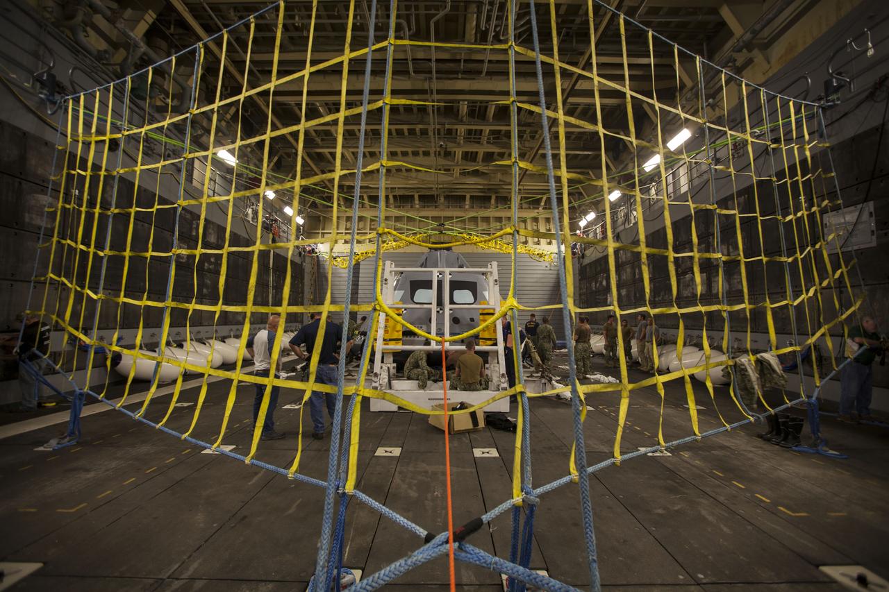 A test version of the Orion crew module is secured in the well deck of the USS San Diego for Underway Recovery Test 5. NASA's Ground Systems Development and Operations Program and the U.S. Navy will conduct a series of tests using the ship's well deck, the test module, various watercraft and equipment to prepare for recovery of Orion on its return from deep space missions. The test will allow the team to demonstrate and evaluate recovery processes, procedures, hardware and personnel in open waters. Orion is the exploration spacecraft designed to carry astronauts to destinations not yet explored by humans, including an asteroid and NASA's Journey to Mars. It will have emergency abort capability, sustain the crew during space travel and provide safe re-entry from deep space return velocities. Orion is scheduled to launch on NASA's Space Launch System in late 2018. For more information, visit http://www.nasa.gov/orion. 