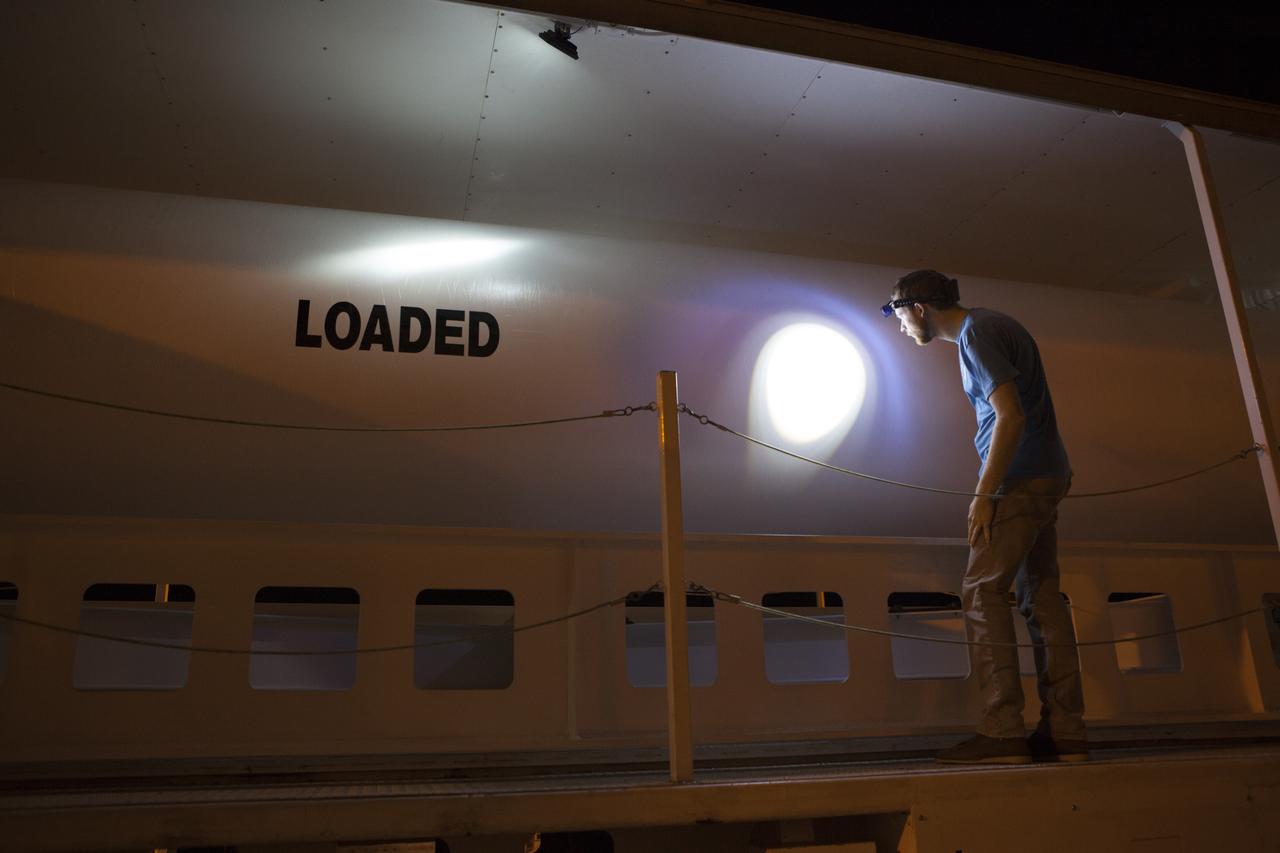 A United Launch Alliance (ULA) technician inspects the solid rocket motor for the ULA Atlas V rocket on its transporter near the Vertical Integration Facility at Space Launch Complex 41 at Cape Canaveral Air Force Station in Florida. The solid rocket motor will be lifted and mated to the rocket in preparation for the launch of NOAA's Geostationary Operational Environmental Satellite (GOES-R) this month. GOES-R is the first satellite in a series of next-generation NOAA GOES Satellites.