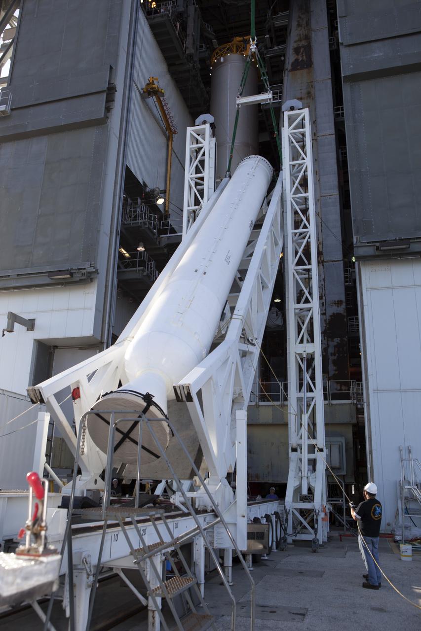 The solid rocket motor is lifted on its transporter for mating to the United Launch Alliance Atlas V rocket in the Vertical Integration Facility at Space Launch Complex 41 at Cape Canaveral Air Force Station in Florida. NOAA's Geostationary Operational Environmental Satellite (GOES-R) will launch aboard the Atlas V rocket this month. GOES-R is the first satellite in a series of next-generation NOAA GOES Satellites.