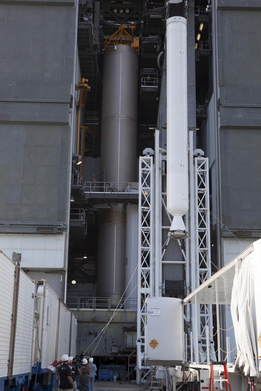The solid rocket motor has been lifted to the vertical position on its transporter for mating to the United Launch Alliance Atlas V rocket in the Vertical Integration Facility at Space Launch Complex 41 at Cape Canaveral Air Force Station in Florida. NOAA's Geostationary Operational Environmental Satellite (GOES-R) will launch aboard the Atlas V rocket this month. GOES-R is the first satellite in a series of next-generation NOAA GOES Satellites.