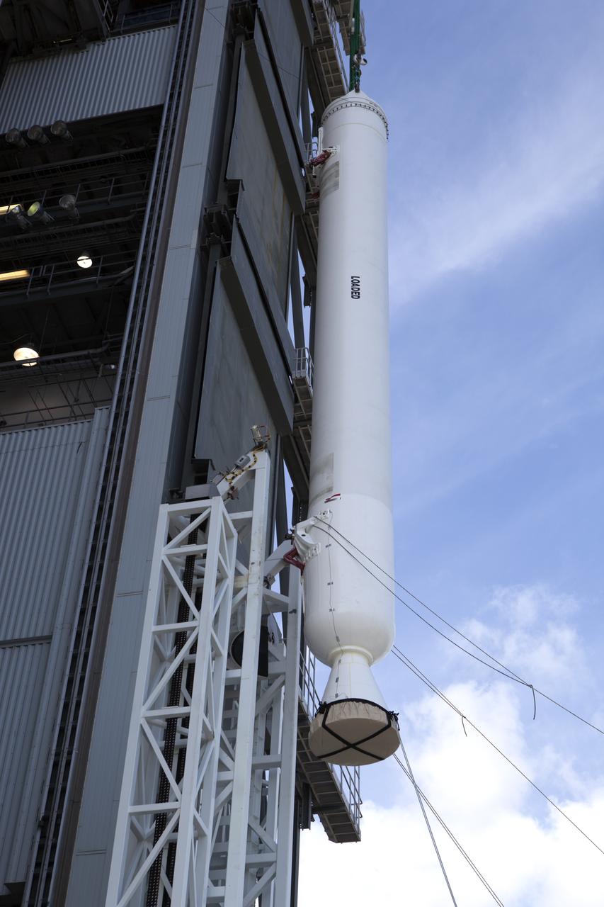 The solid rocket motor has been lifted to the vertical position for mating to the United Launch Alliance Atlas V rocket in the Vertical Integration Facility at Space Launch Complex 41 at Cape Canaveral Air Force Station in Florida. NOAA's Geostationary Operational Environmental Satellite (GOES-R) will launch aboard the Atlas V rocket this month. GOES-R is the first satellite in a series of next-generation NOAA GOES Satellites.