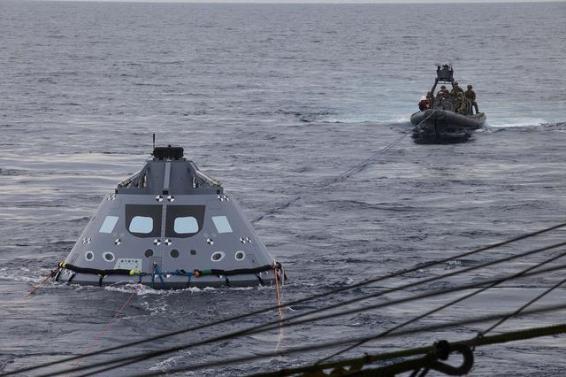 U.S. Navy divers and other personnel in a rigid hull Zodiac boat have attached tether lines to a test version of the Orion crew module during Underway Recovery Test 5 in the Pacific Ocean off the coast of California. NASA's Ground Systems Development and Operations Program and the U.S. Navy are conducting a series of tests using the USS San Diego, various watercraft and equipment to practice for recovery of Orion on its return from deep space missions. The testing will allow the team to demonstrate and evaluate recovery processes, procedures, hardware and personnel in open waters. Orion is the exploration spacecraft designed to carry astronauts to destinations not yet explored by humans, including an asteroid and NASA's Journey to Mars. It will have emergency abort capability, sustain the crew during space travel and provide safe re-entry from deep space return velocities. Orion is scheduled to launch on NASA's Space Launch System in late 2018. For more information, visit http://www.nasa.gov/orion. 