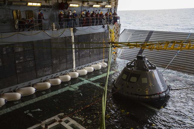 A test version of the Orion crew module has been tethered and pulled into the well deck of the USS San Diego using a winch system during the second day of Underway Recovery Test 5 in the Pacific Ocean off the coast of California. NASA's Ground Systems Development and Operations Program and the U.S. Navy are conducting a series of tests to prepare for recovery of Orion on its return from deep space missions. The testing will allow the team to demonstrate and evaluate recovery processes, procedures, hardware and personnel in open waters. Orion is the exploration spacecraft designed to carry astronauts to destinations not yet explored by humans, including an asteroid and NASA's Journey to Mars. It will have emergency abort capability, sustain the crew during space travel and provide safe re-entry from deep space return velocities. Orion is scheduled to launch on NASA's Space Launch System in late 2018. For more information, visit http://www.nasa.gov/orion.
