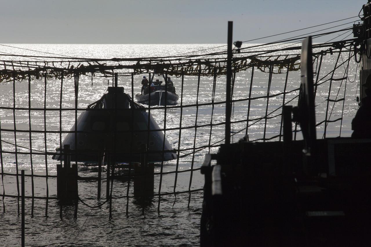 A test version of the Orion crew module is guided into the flooded well deck of the USS San Diego during Underway Recovery Test 5 in the Pacific Ocean off the coast of California. Recovery team personnel in a rigid hull inflatable boat have secured tether lines to the crew module. NASA's Ground Systems Development and Operations Program and the U.S. Navy are conducting a series of tests to prepare for recovery of Orion on its return from deep space missions. The testing will allow the team to demonstrate and evaluate recovery processes, procedures, hardware and personnel in open waters. Orion is the exploration spacecraft designed to carry astronauts to destinations not yet explored by humans, including an asteroid and NASA's Journey to Mars. It will have emergency abort capability, sustain the crew during space travel and provide safe re-entry from deep space return velocities. Orion is scheduled to launch on NASA's Space Launch System in late 2018. For more information, visit http://www.nasa.gov/orion.