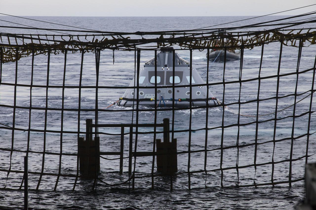 A test version of the Orion crew module is guided into the well deck of the USS San Diego during Underway Recovery Test 5 in the Pacific Ocean off the coast of California. Tether lines have been attached to the crew module by U. S. Navy divers and other personnel in a rigid hull inflatable boat.  NASA's Ground Systems Development and Operations Program and the U.S. Navy are practicing recovery techniques to prepare for recovery of Orion on its return from deep space missions. The testing will allow the team to demonstrate and evaluate recovery processes, procedures, hardware and personnel in open waters. Orion is the exploration spacecraft designed to carry astronauts to destinations not yet explored by humans, including an asteroid and NASA's Journey to Mars. It will have emergency abort capability, sustain the crew during space travel and provide safe re-entry from deep space return velocities. Orion is scheduled to launch on NASA's Space Launch System in late 2018. For more information, visit http://www.nasa.gov/orion.
