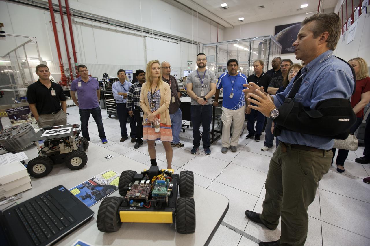 Jenn Gustetic, NASA's Small Business Innovation Research Program executive, talks with Rob Mueller, senior technologist and co-founder of Kennedy Space Center's Swamp Works. Gustetic met team members and viewed many of the pioneering technologies and innovations in development at Kennedy. Swamp Works is a hands-on, lean development environment for innovation following the philosophies pioneered in Kelly Johnson's Skunk Works and Werner von Braun's development shops. The Swamp Works establishes rapid, innovative and cost-effective exploration mission solutions through a highly collaborative, "no walls" approach, leveraging partnerships across NASA, industry and academia.