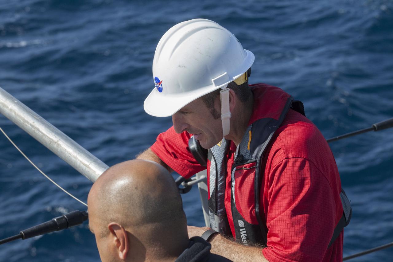 Recovery team members watch Orion Underway Recovery Test 5 activities on the flight deck of the USS San Diego in the Pacific Ocean off the coast of California. NASA's Ground Systems Development and Operations Program and the U.S. Navy are practicing recovery techniques using the well deck of the ship and a test version of the Orion crew module to prepare for recovery of Orion on its return from deep space missions. The testing will allow the team to demonstrate and evaluate recovery processes, procedures, hardware and personnel in open waters. Orion is the exploration spacecraft designed to carry astronauts to destinations not yet explored by humans, including an asteroid and NASA's Journey to Mars. It will have emergency abort capability, sustain the crew during space travel and provide safe re-entry from deep space return velocities. Orion is scheduled to launch on NASA's Space Launch System in late 2018. For more information, visit http://www.nasa.gov/orion. 