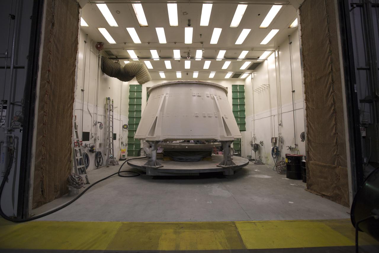 The right hand aft skirt for NASA's Space Launch System (SLS) rocket has been painted and is in a drying cell in a support building at the Hangar AF facility at Cape Canaveral Air Force Station in Florida. The space shuttle-era aft skirt will be used on the right hand booster of NASA's Space Launch System rocket for Exploration Mission 1 (EM-1). NASA is preparing for EM-1, deep space missions, and the Journey to Mars. 