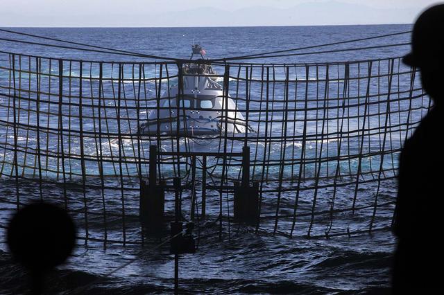 A test version of the Orion crew module floats outside the well deck of the USS San Diego on the fourth day of Underway Recovery Test 5 in the Pacific Ocean off the coast of California. NASA's Ground Systems Development and Operations Program and the U.S. Navy are practicing retrieving and securing the crew module in the well deck of the ship using tethers and a winch system to prepare for recovery of Orion on its return from deep space missions. The testing will allow the team to demonstrate and evaluate recovery processes, procedures, hardware and personnel in open waters. Orion is the exploration spacecraft designed to carry astronauts to destinations not yet explored by humans, including an asteroid and NASA's Journey to Mars. It will have emergency abort capability, sustain the crew during space travel and provide safe re-entry from deep space return velocities. Orion is scheduled to launch on NASA's Space Launch System in late 2018. For more information, visit http://www.nasa.gov/orion.